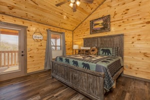 Bedroom with a king bed and deck access at Everlys Splash, a 4 bedroom cabin rental located in Pigeon Forge