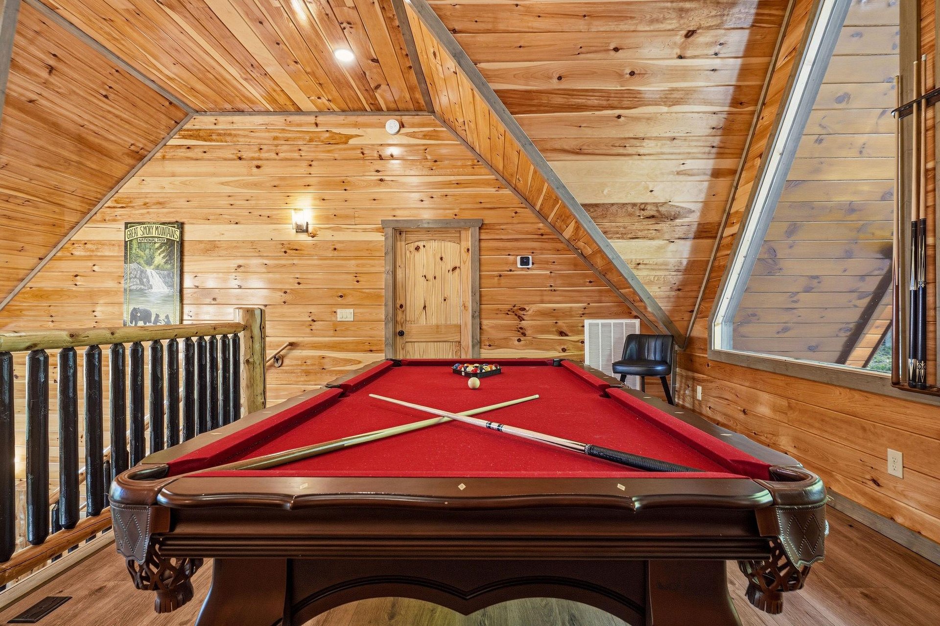 Challenge friends to a game on your private pool table in this cozy woodpaneled loft space.