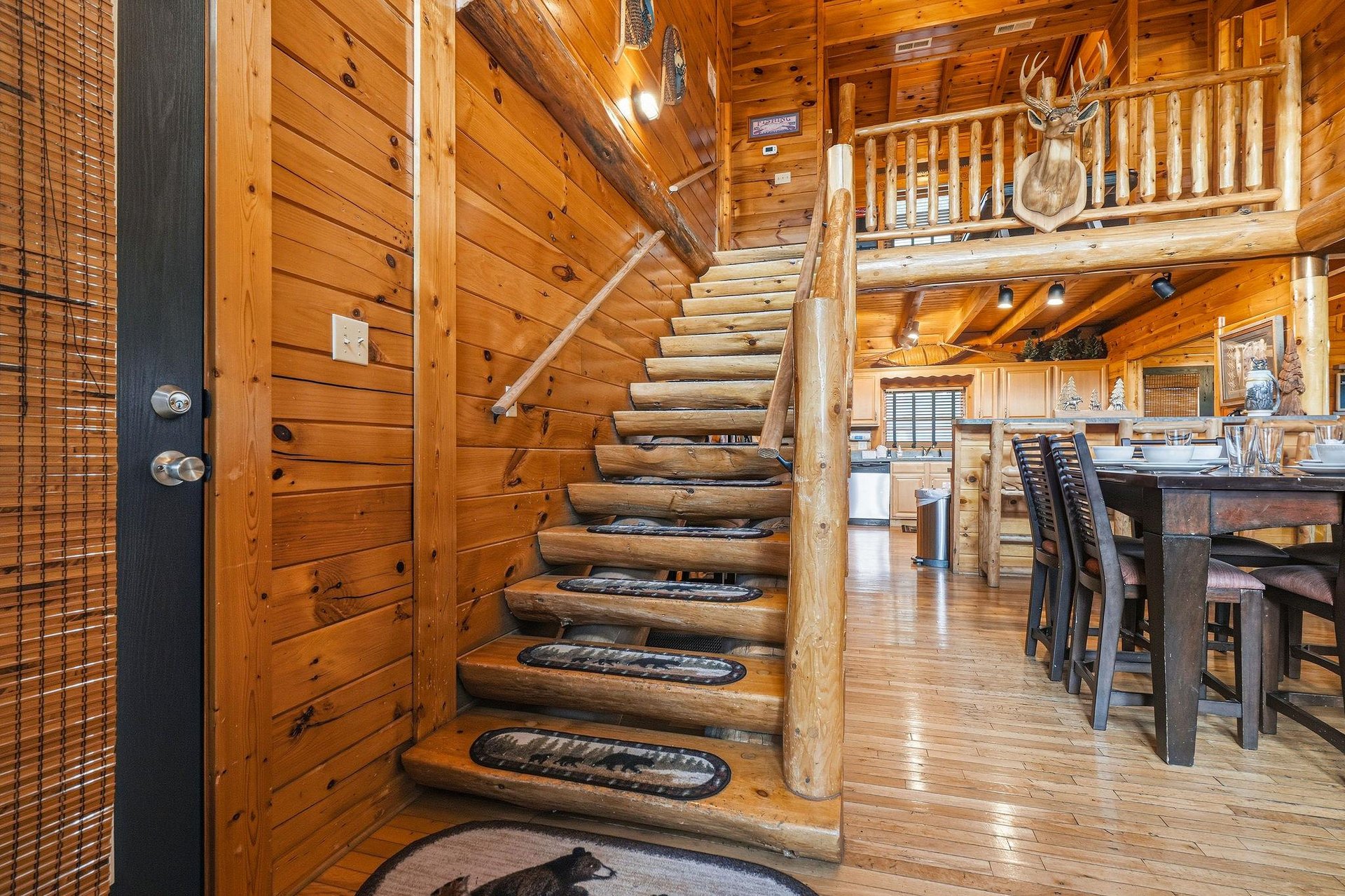 Step into your rustic cabin retreat, where warm wood surrounds you and a soaring loft overlooks the spacious living and dining area. Natural light streams through every corner, inviting you to unwind 