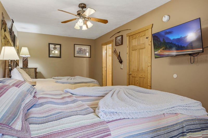 Sink into plush linens and rest easy in this cozy bedroom, where rustic charm and modern comfort meet. Fresh towels await your arrival.