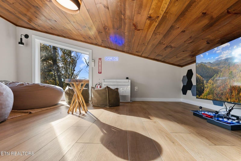 Your personal game loft awaits under stunning woodbeamed ceilings, with natural light streaming through real windows. Warm wood floors and cozy bean bags invite you to unwind between epic matches.