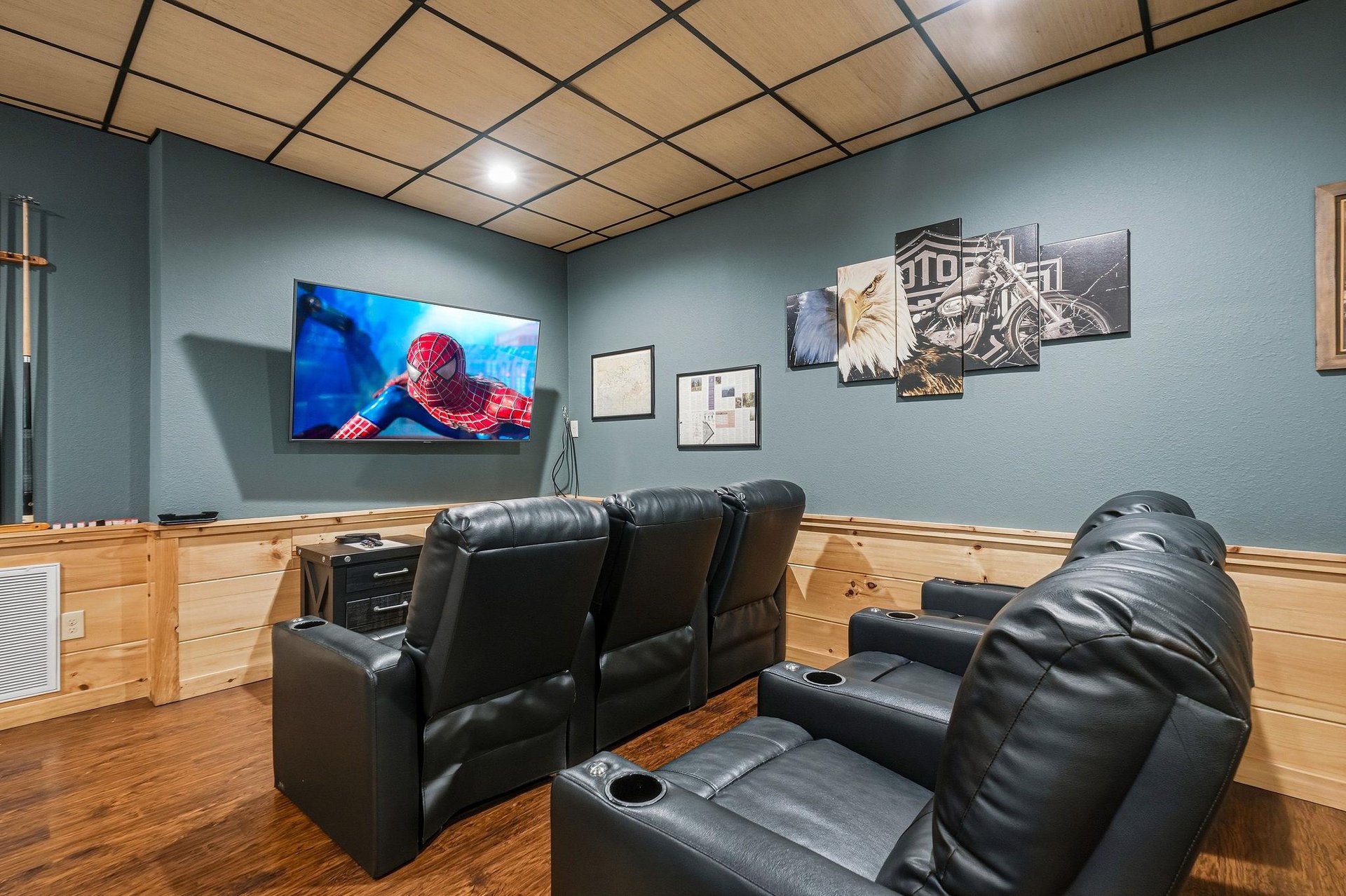 Sink into plush leather recliners and enjoy your favorite movies on the big screen in this cozy home theater room.