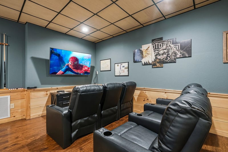 Sink into plush leather recliners and enjoy your favorite movies on the big screen in this cozy home theater room.