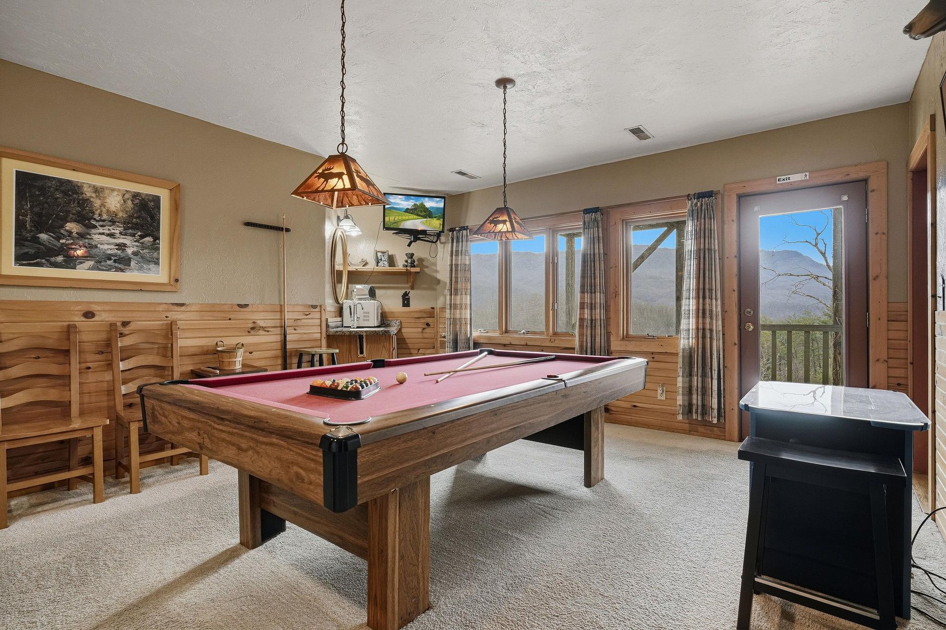 Challenge friends to pool while mountain views inspire your next shot through panoramic windows.
