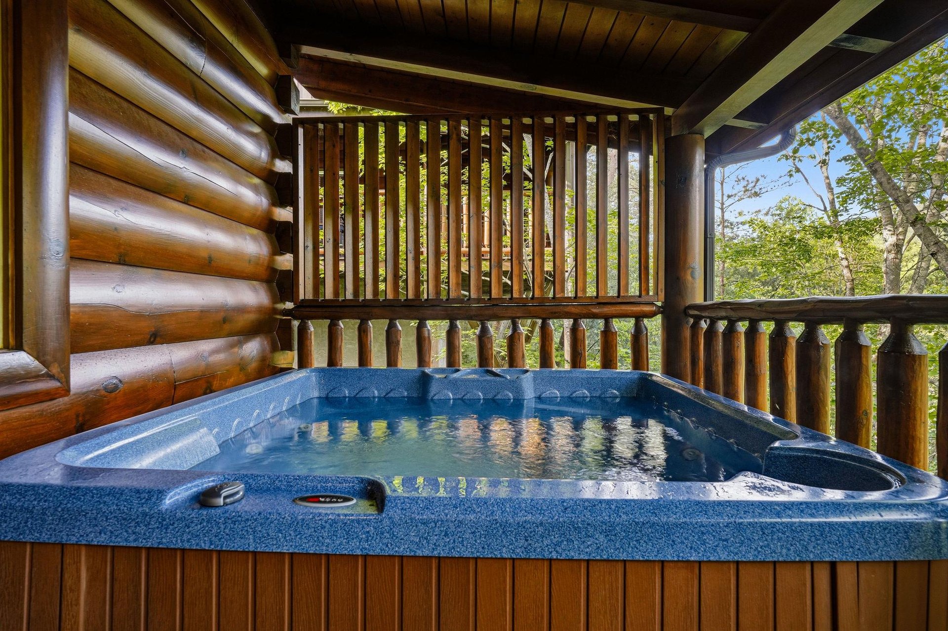 Soak in your private hot tub surrounded by rich wood beams and forest views—pure mountain tranquility awaits.