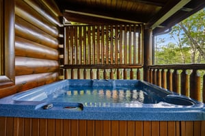 Soak in your private hot tub surrounded by rich wood beams and forest views—pure mountain tranquility awaits.