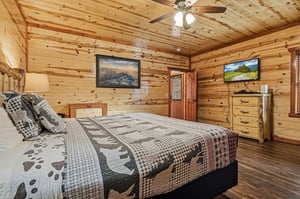 Unwind in this cozy log cabin bedroom where rustic charm meets modern comfort for your perfect mountain getaway.
