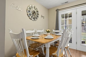 Gather around your charming dining table where morning coffee and evening meals become cherished memories beneath inspiring wall art.