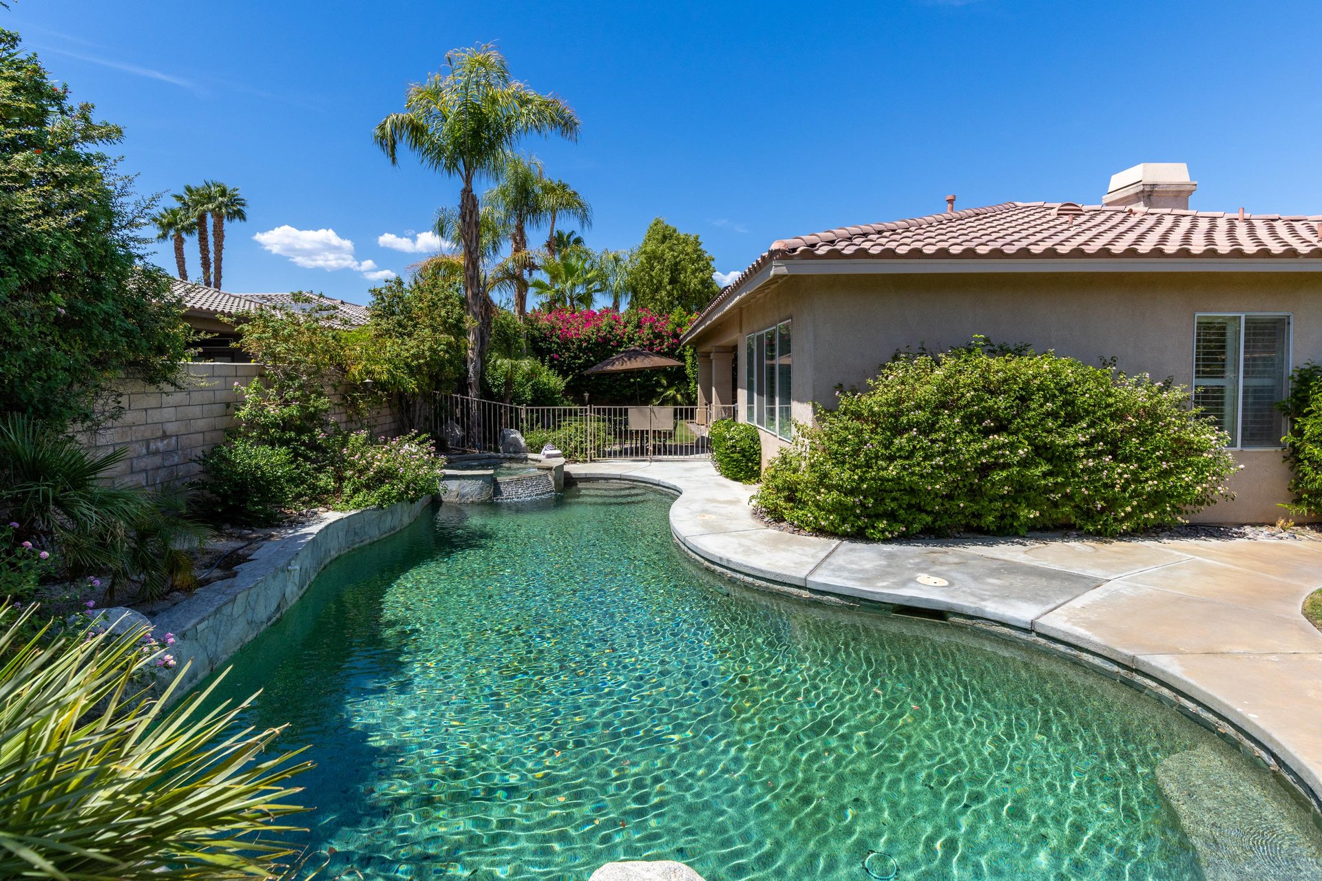 Private pool, spa, outdoor dining area, BBQ, fire pit, and lawn.