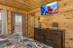 Dresser, TV, and deck access at Everlys Splash, a 4 bedroom cabin rental located in Pigeon Forge