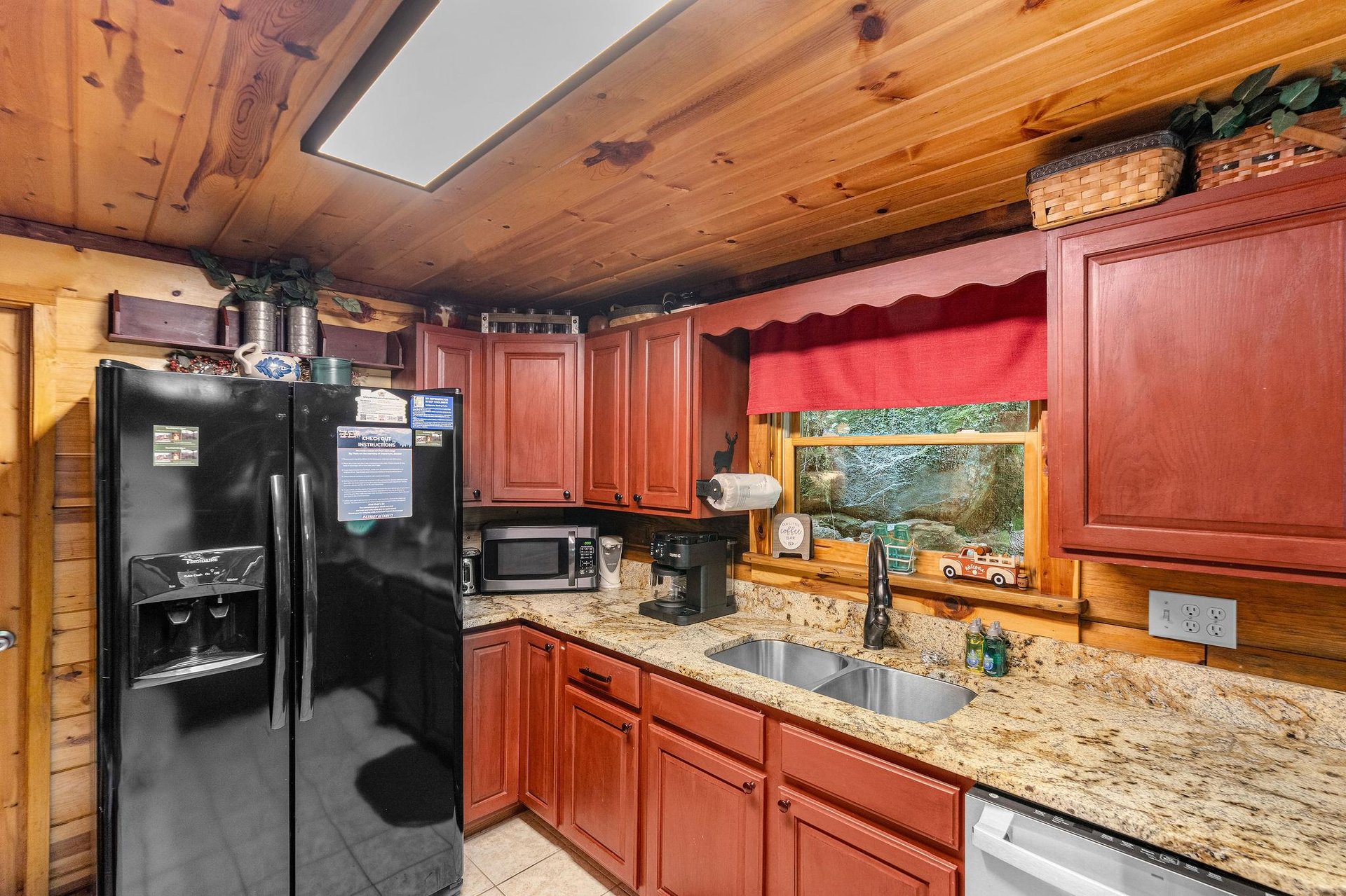 Full kitchen with red wood cabinets