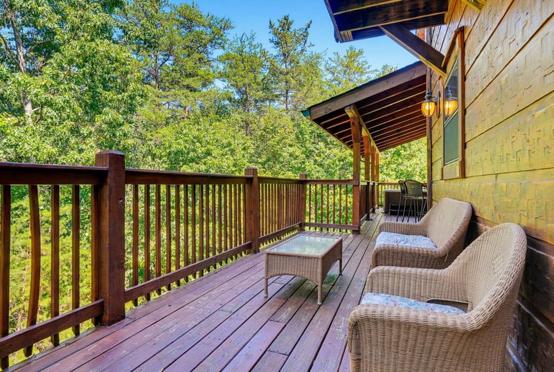 Your private deck invites peaceful mornings with plush seating overlooking lush forest views—a perfect retreat for quiet moments surrounded by nature.