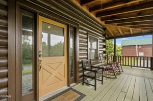 Settle into your own rocking chair on this spacious covered porch, wrapped by rustic wood beams and open views of the surrounding neighborhood.