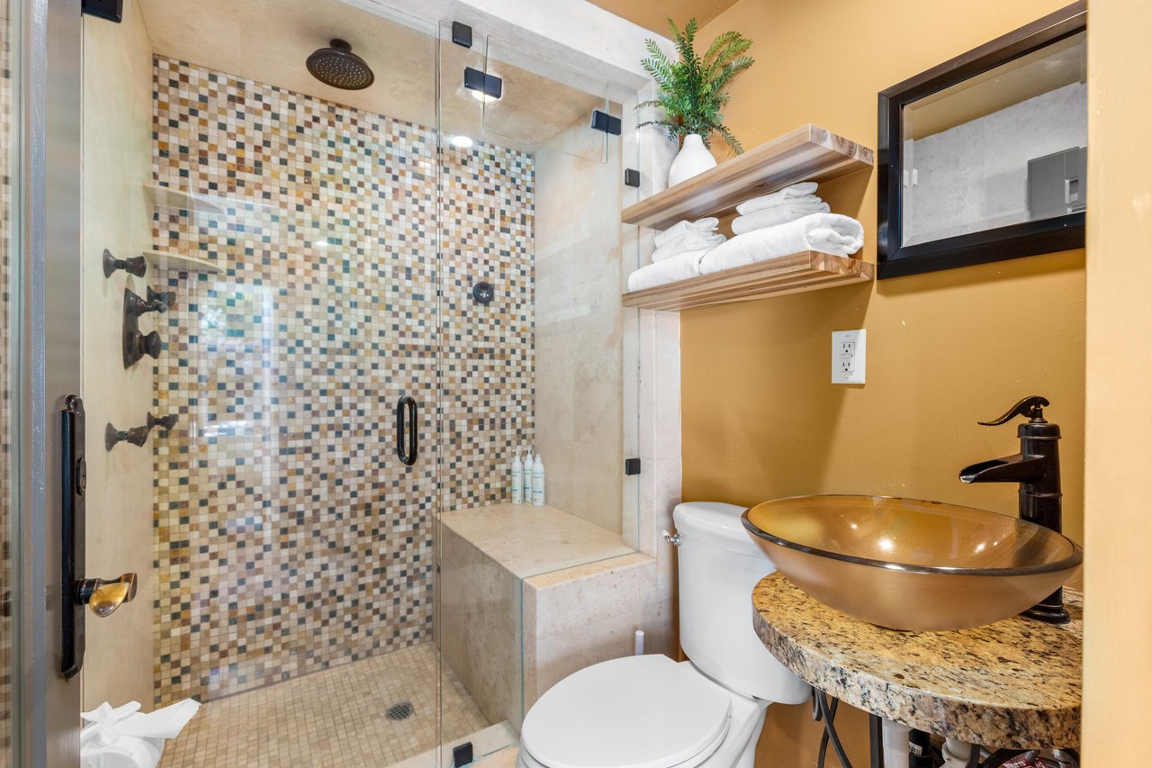 Pool bathroom with standalone shower, access from patio.