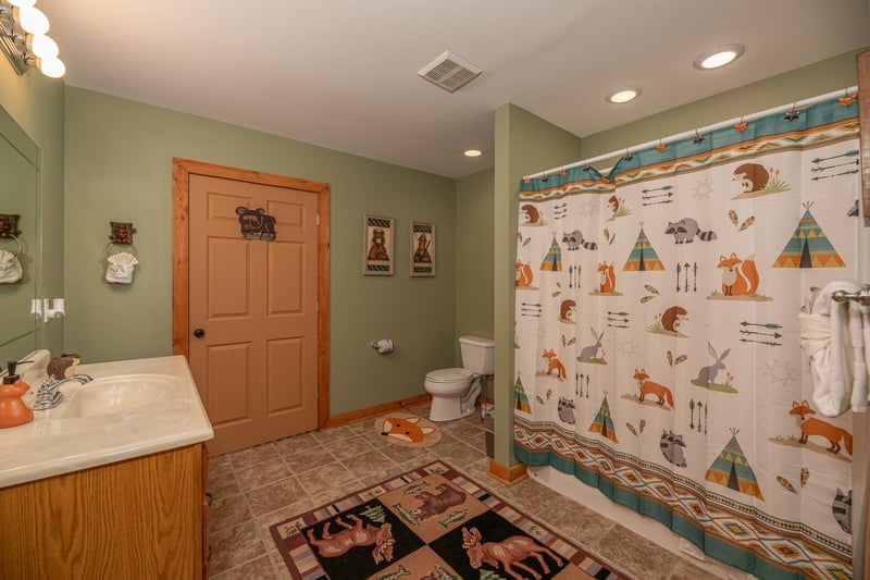 Bathroom with a tub and shower at Lazy Bear Retreat, a 4 bedroom cabin rental located in Pigeon Forge