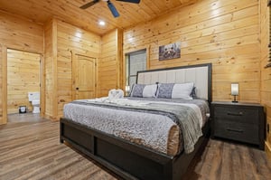 Drift off in your cozy cabin bedroom, surrounded by warm wood walls and mountaininspired decor that creates the perfect retreat.