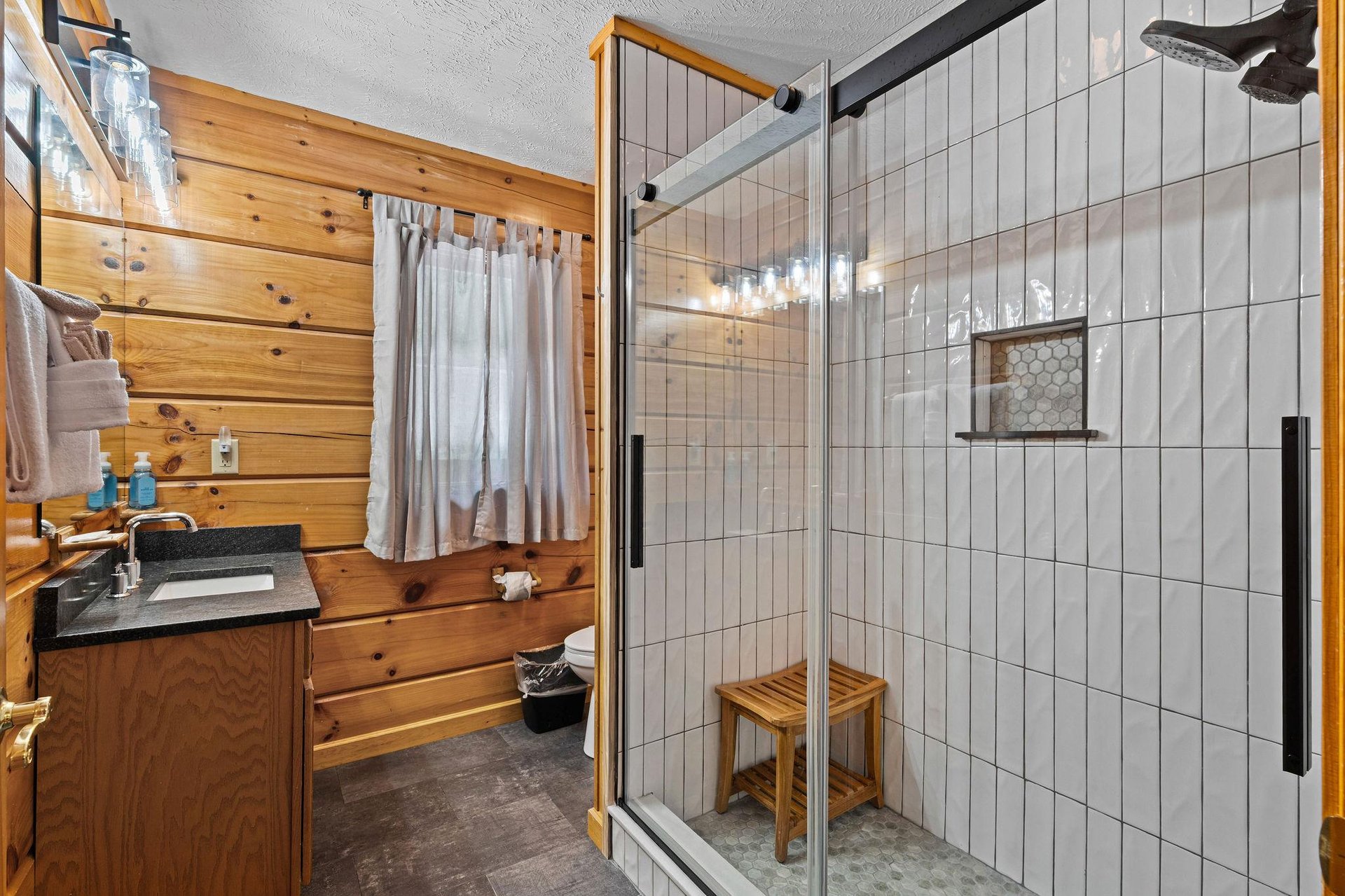 Walkin in shower with seat and single vanity sink