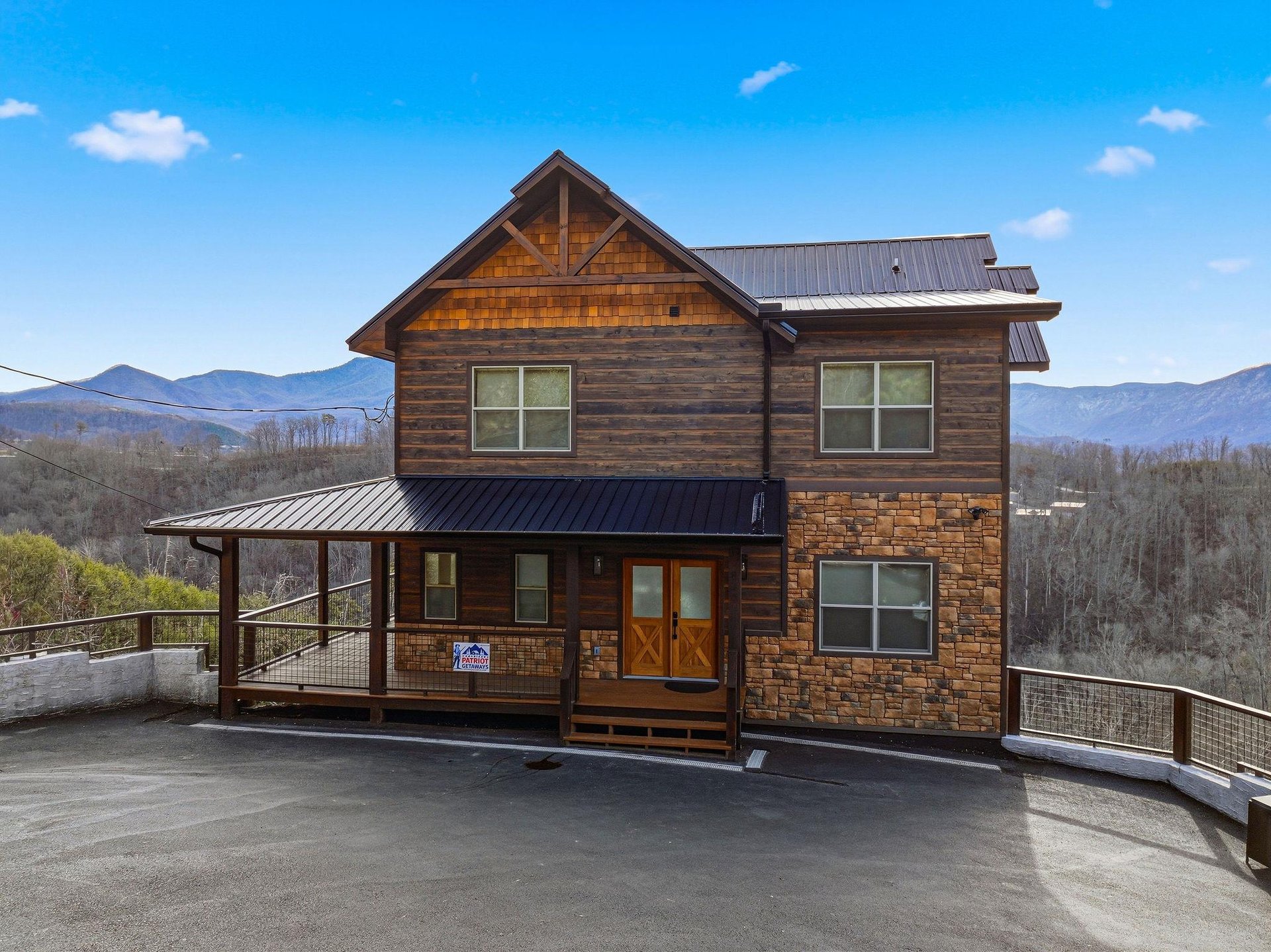 Rustic mountain cabin with stunning panoramic views, featuring natural wood and stone construction set against rolling mountain landscapes.