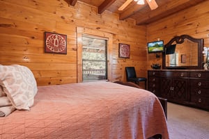 Sink into the comfort of your cozy cabin bedroom, where warm wood walls and mountain charm create the perfect retreat after a day of adventure.