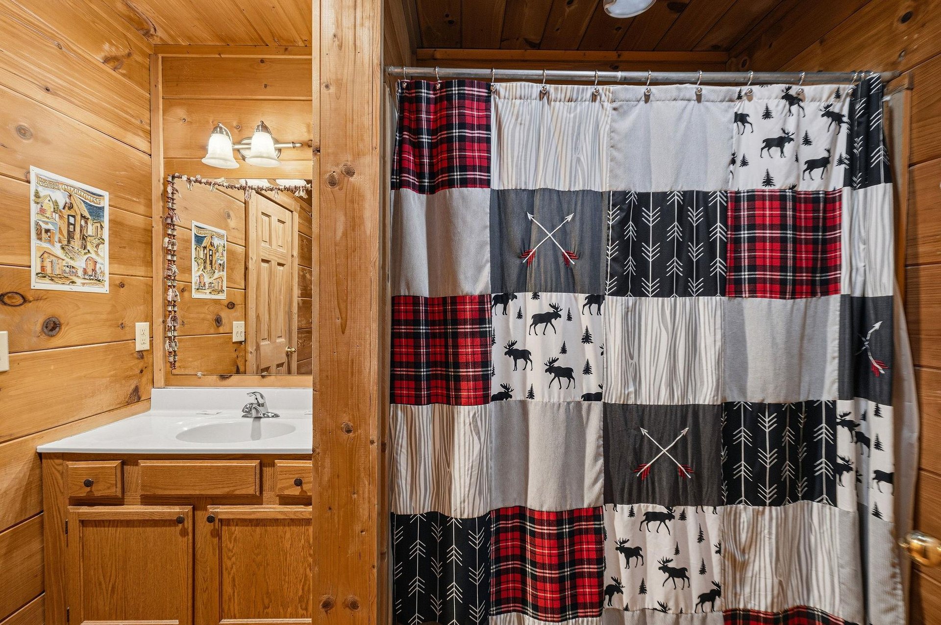 Step into your cozy cabin bathroom where rustic charm meets comfort with handcrafted patchwork shower curtain and warm wood surroundings.