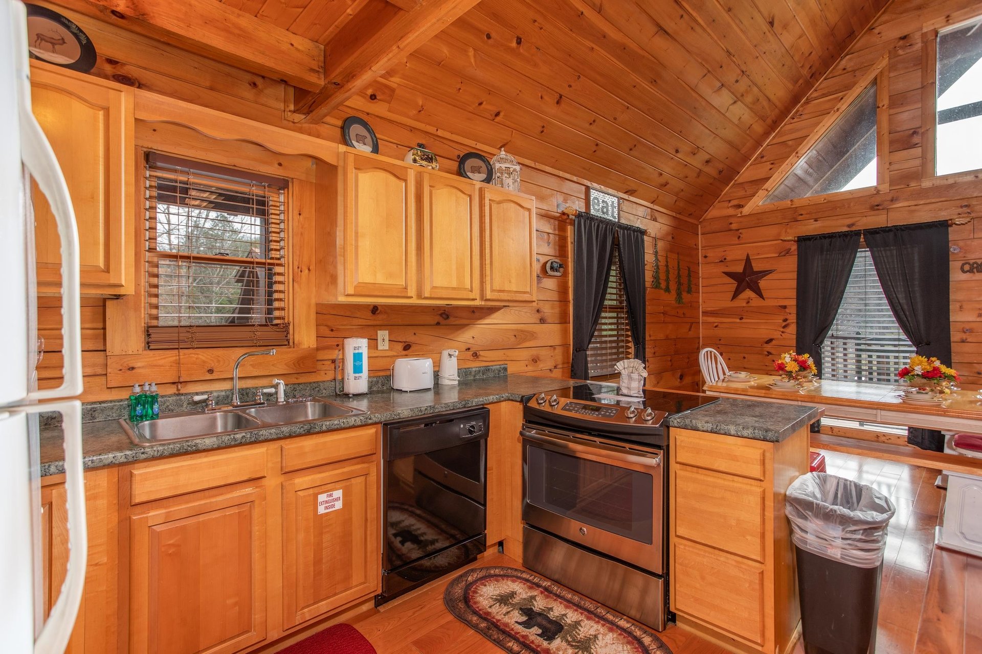 Kitchen with counter top seating and a dining space for six at Hibernation Station, a 3bedroom cabin rental located in Pigeon Forge