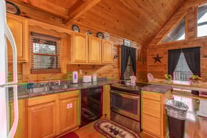 Kitchen with counter top seating and a dining space for six at Hibernation Station, a 3bedroom cabin rental located in Pigeon Forge