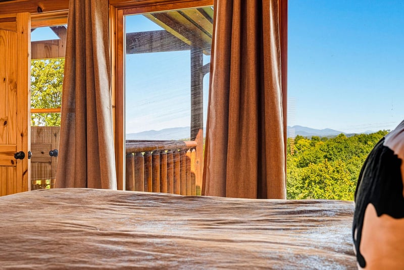 Wake up to stunning mountain views framed by gentle curtains and warm wooden beams. Step onto your private deck and breathe in the fresh countryside air as sunlight dances through the trees.