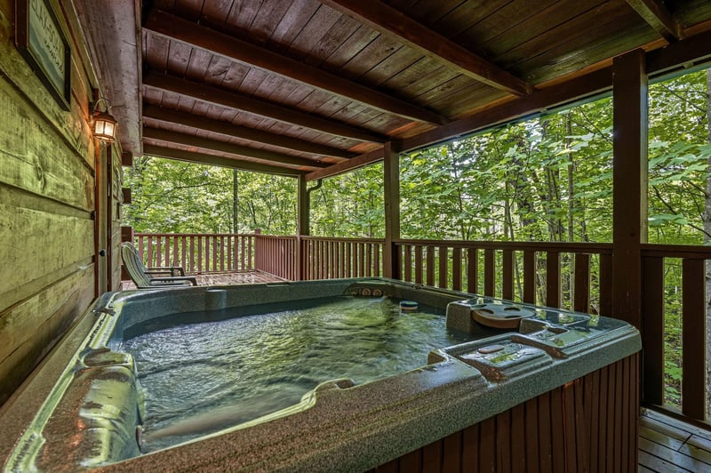 Slip into your private hot tub on the covered deck and let the warm bubbles melt away your stress while youre surrounded by tranquil forest views.