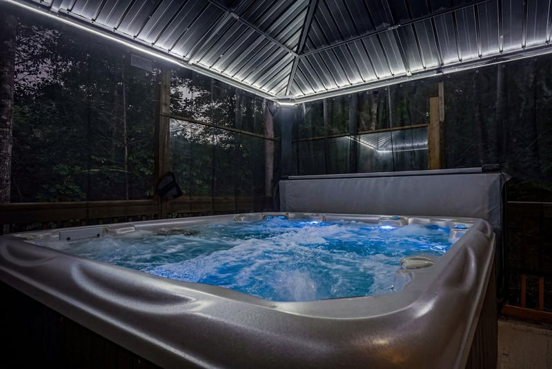 Slip into your private hot tub beneath a skylight framing the forest canopy, where gentle jets ease away tension as evening settles softly around you.