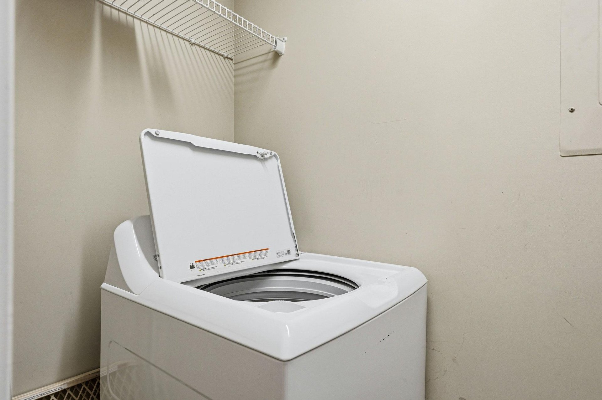 Keep your wardrobe fresh with convenient inunit laundry facilities, complete with wire shelving for easy organization.