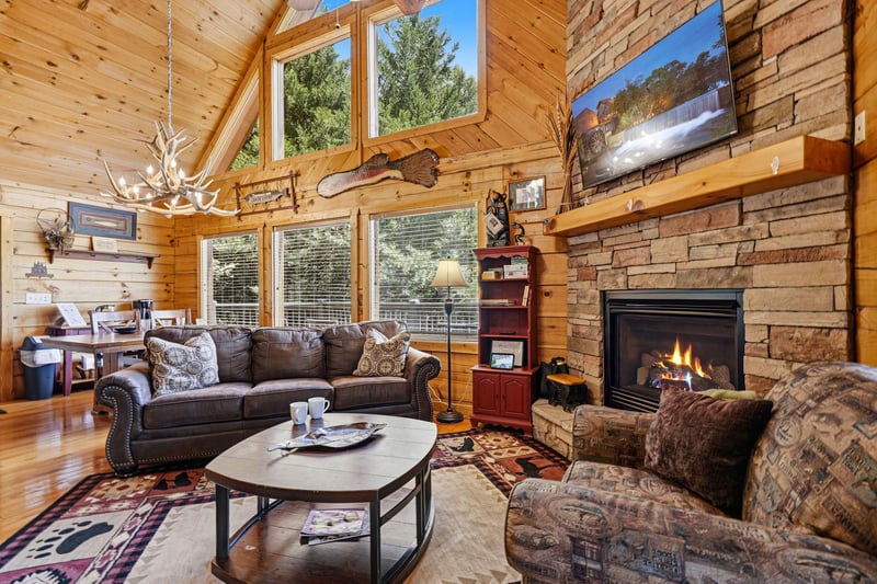 Sink into plush sofas by the crackling stone fireplace, surrounded by soaring woodpaneled ceilings and sunlight streaming through tall windows. Your cozy mountain retreat awaits.