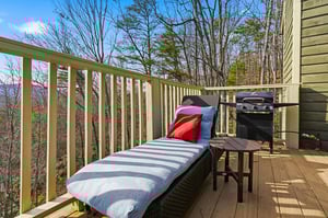 Unwind on your private deck where a cozy lounge chair awaits with mountain views through the trees, plus a BBQ for memorable outdoor meals.