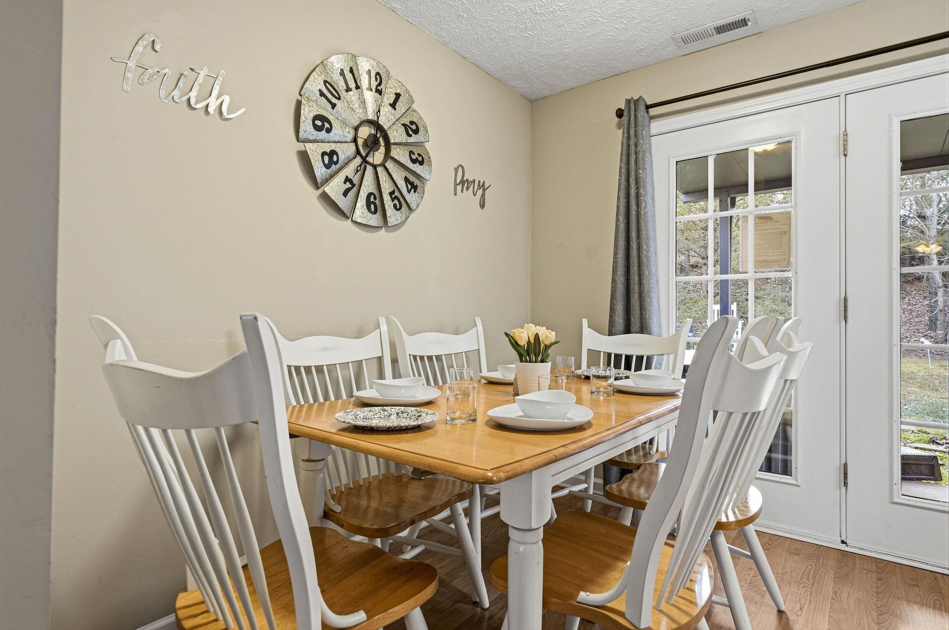 Gather around your charming dining table where morning coffee and evening meals become cherished memories beneath inspiring wall art.