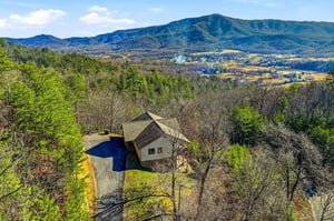 Elevated mountain retreat nestled among rolling hills with sweeping valley views and private swimming pool surrounded by nature.
