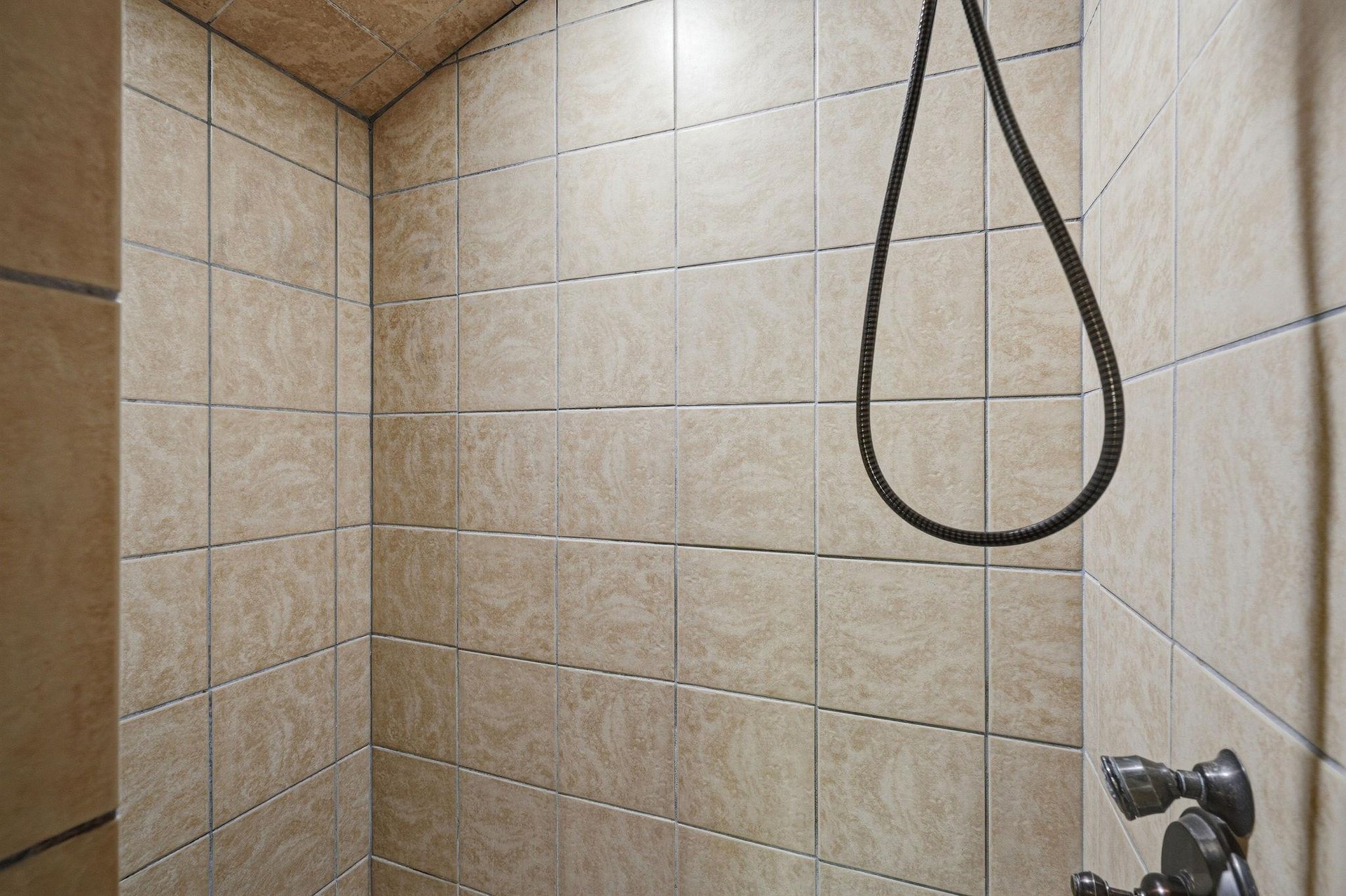 Step into your beautifully tiled shower with elegant ceramic walls and modern fixtures for a refreshing start to your day.