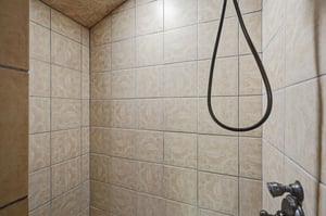 Step into your beautifully tiled shower with elegant ceramic walls and modern fixtures for a refreshing start to your day.