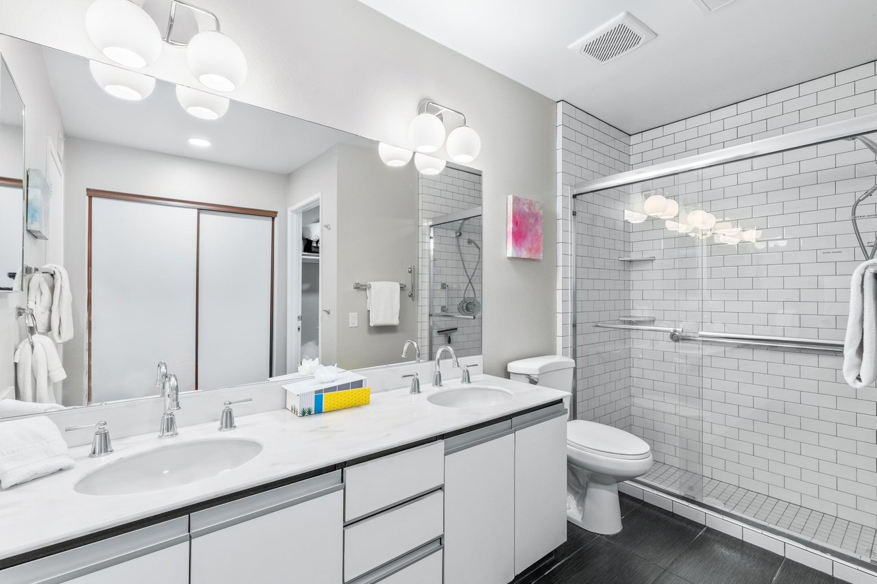 Ensuite bathroom with dual vanity sinks and walkin shower.
