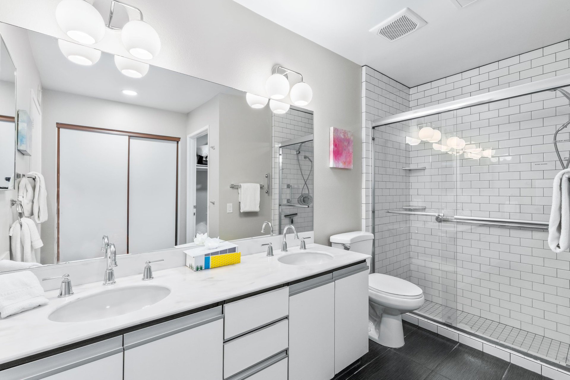 Ensuite bathroom with dual vanity sinks and walkin shower.