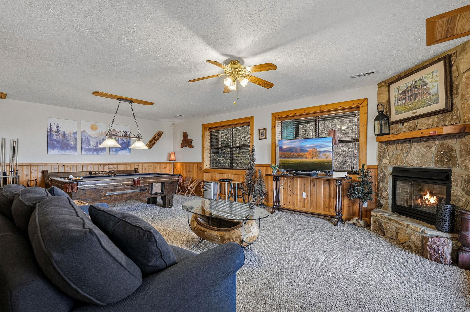 Cozy up in your rustic retreat with warm wood accents, crackling fireplace, and pool table for endless entertainment.