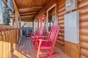 side porch with rocking chairs and hot tub