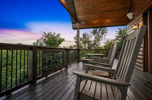 Watch the sky paint itself in brilliant blues and soft pastels from your private deck, where tranquil treetop views and Adirondack seating invite you to unwind completely.