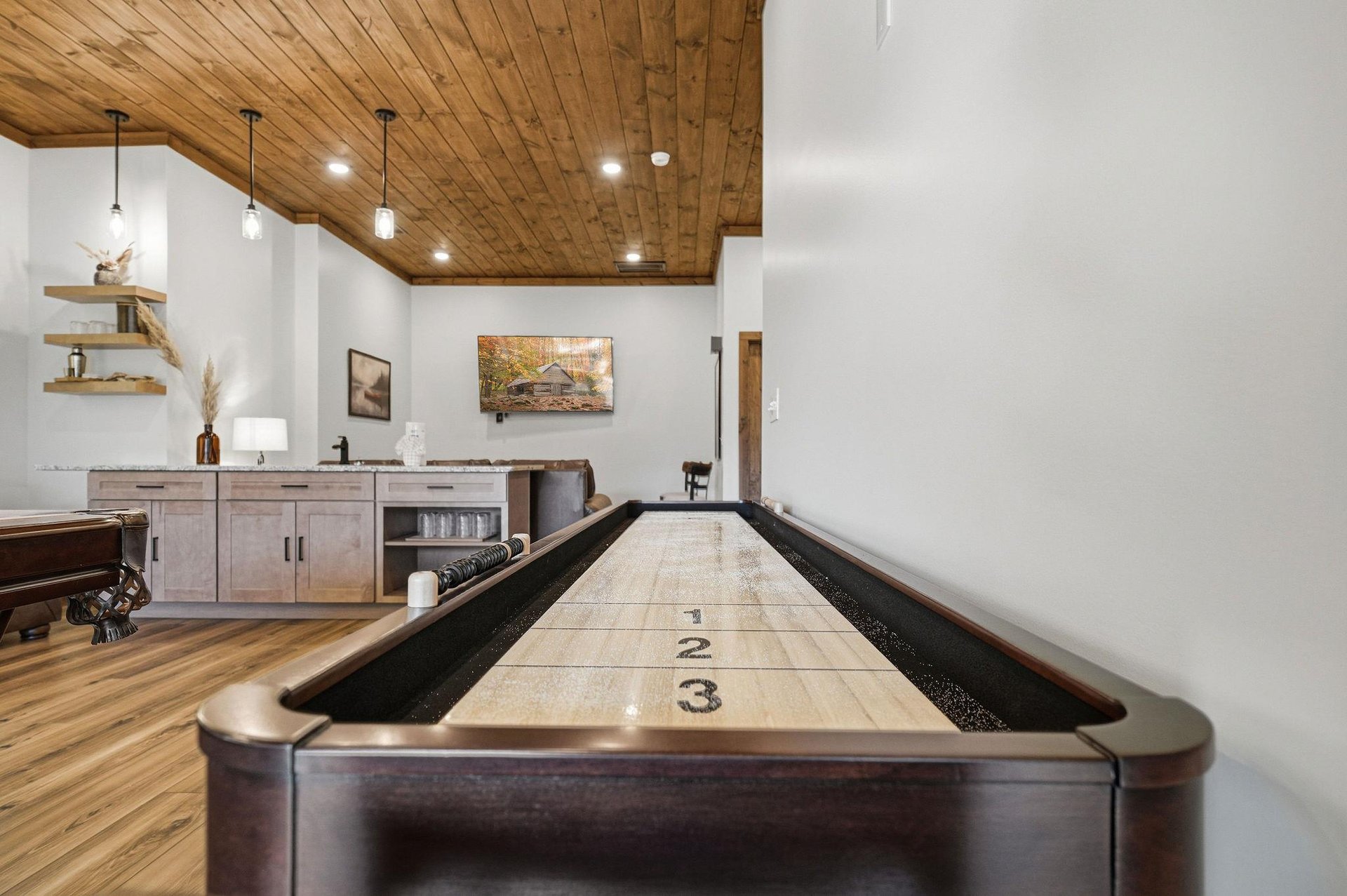 Challenge friends to shuffleboard under stunning wood ceilings in your game room, complete with wet bar for refreshments.