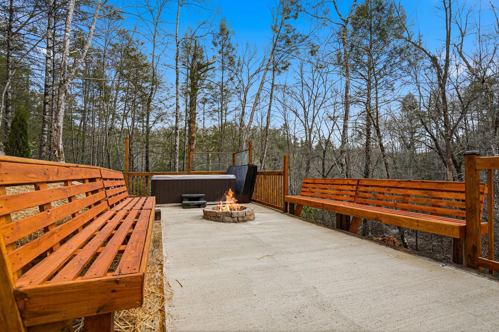 Unwind on your private deck with hot tub, fire pit, and forest views for perfect mountain evenings.