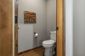 A cozy halfbath with rustic wood accents and serene touches to make your stay comfortable.