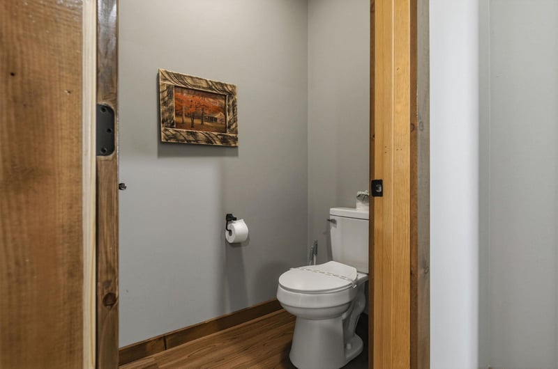 A cozy halfbath with rustic wood accents and serene touches to make your stay comfortable.