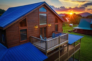 A stunning mountain view from the property with a vibrant sunset illuminating the landscape. The rustic cabin features a spacious deck and is surrounded by peaceful grounds and neighboring cottages.