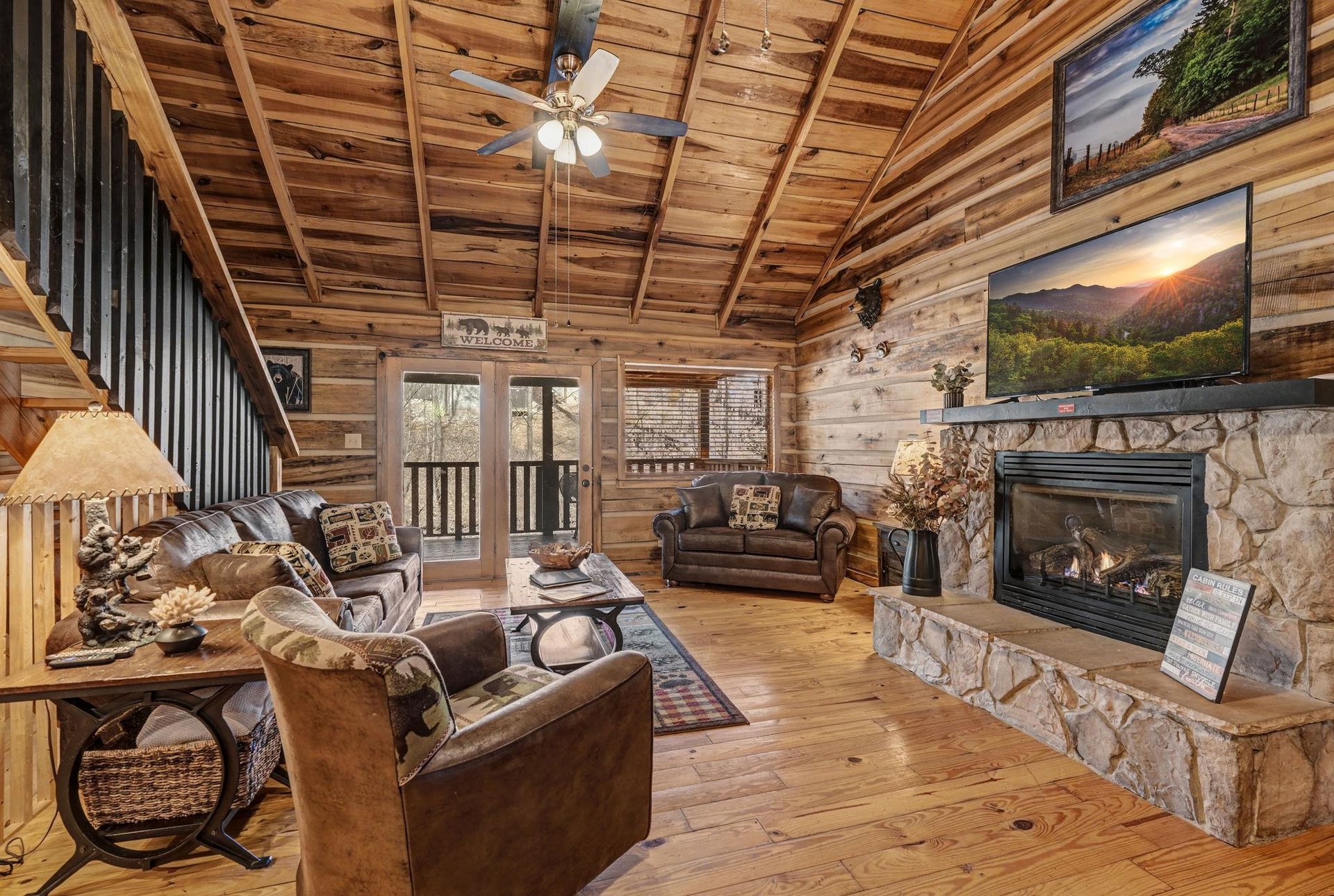 Unwind in your cozy log cabin retreat with exposed beam ceilings, crackling stone fireplace, and rustic leather seating that invites you to relax.