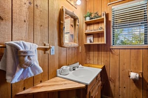 single vanity sink with wood framed mirror