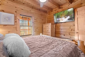 Queen bed with window and tv