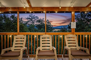 Settle into your deck chairs as twilight paints the sky and mountains beyond, with twinkling town lights creating a peaceful evening backdrop.